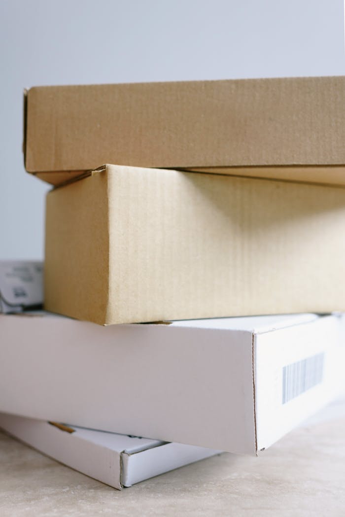 Close-up of stacked cardboard boxes on a marble surface for delivery or storage.